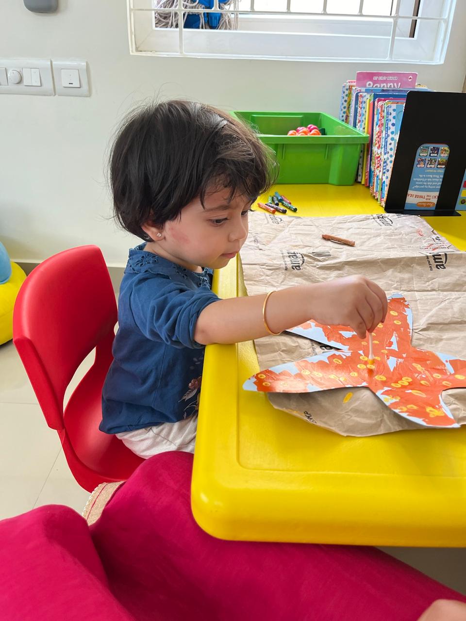 Girl doing art and craft activity in Caterpillar Care Premium Preschool & Daycare