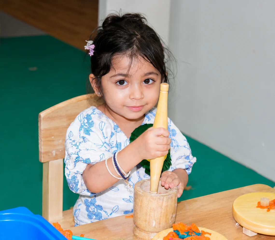 Girl doing clay activity at Caterpillar Care preschool